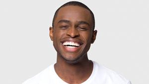 man in white T shirt smiling