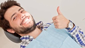 man smiling giving thumbs up