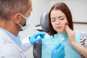 woman tooth pain needing an emergency dentist in Odessa