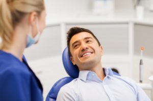 man smiling during his dental implant consultation