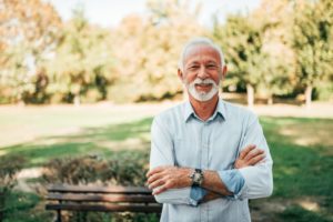 older man smiling with long-lasting dental implants